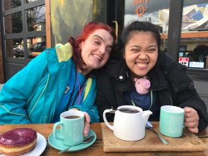 Two women with developmental disabilities sitting outside a cafe
