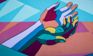 Artwork of two hands in patchwork colours