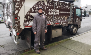 Adam posing with a Goodbye Garbage truck